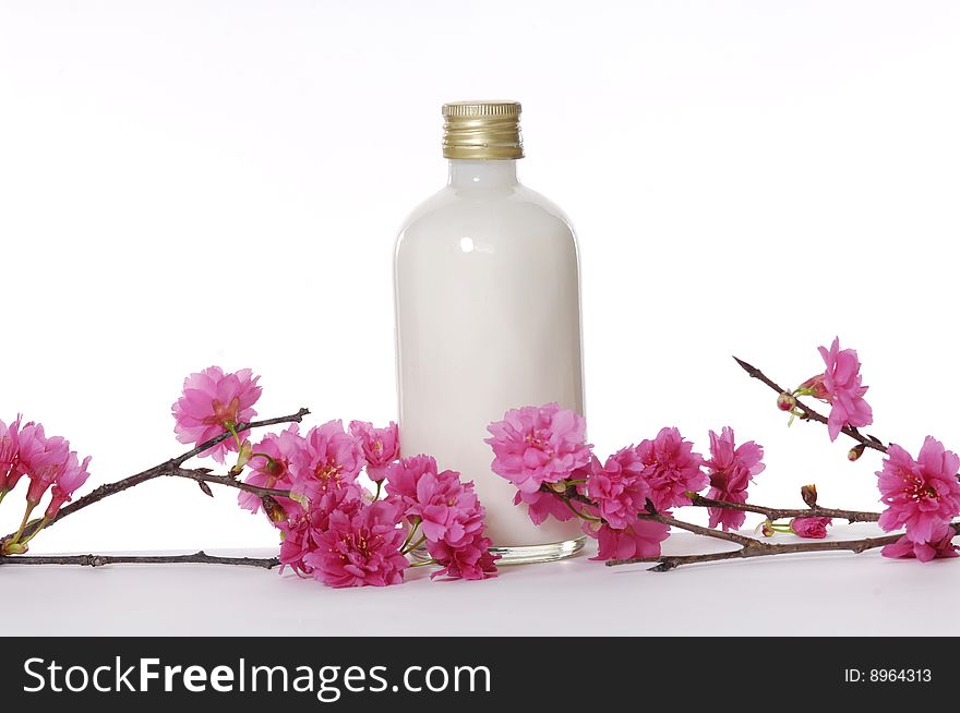 A bottle of massage oil with red flower. A bottle of massage oil with red flower