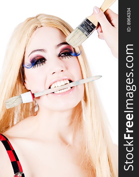Portrait of a blond long haired girl with make-up brushes. Portrait of a blond long haired girl with make-up brushes