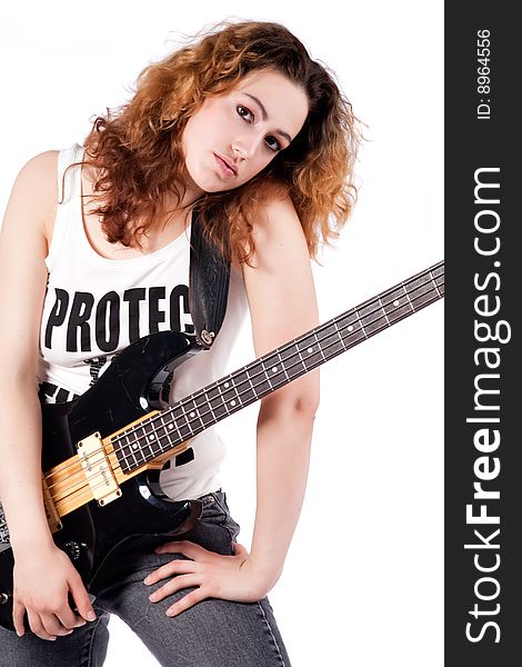 Studio shot of a rock girl posing with her guitar. Studio shot of a rock girl posing with her guitar