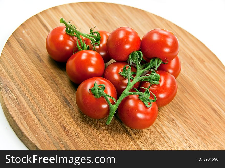 Cherry Tomatoes On A Wooden Cutting Board