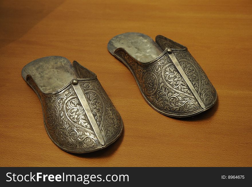 Golden shoes with beautiful decoration, ancient shoes artwork