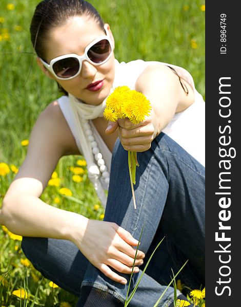 Young Woman In Nature Offering Flowers