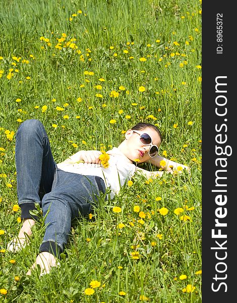 Young Woman Relaxing In Nature Holding Flowers