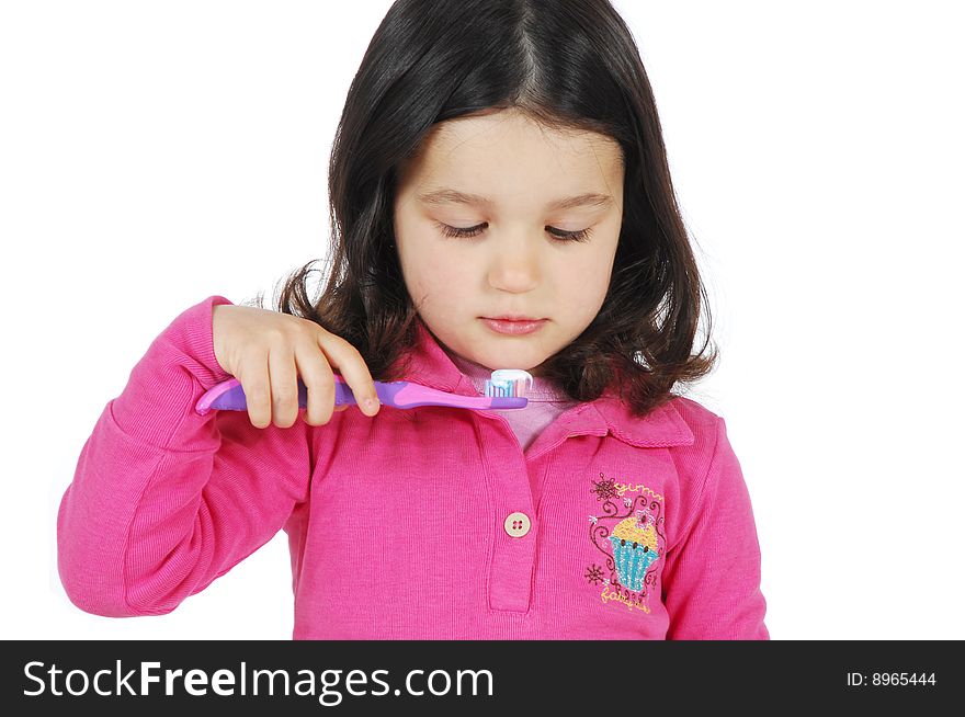 Little cute girl brushing the teeth