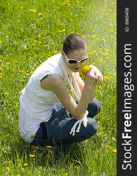 Young woman relaxing in nature holding flowers