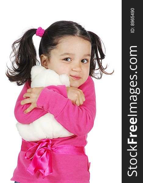 A little girl hugging a teddy bear isolated on white background