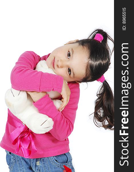 Little girl hugging a teddy bear