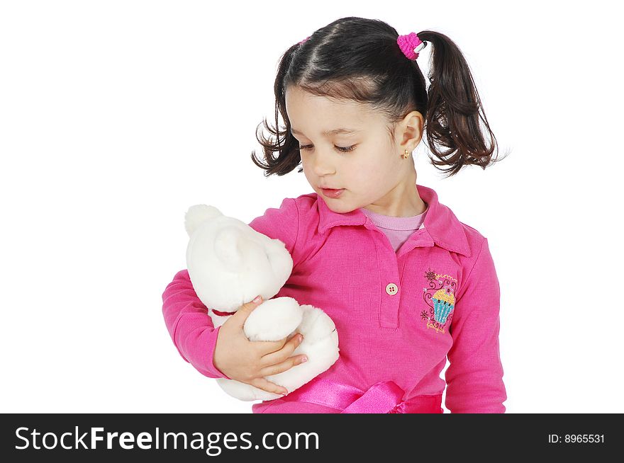 A little girl hugging a teddy bear isolated on white background