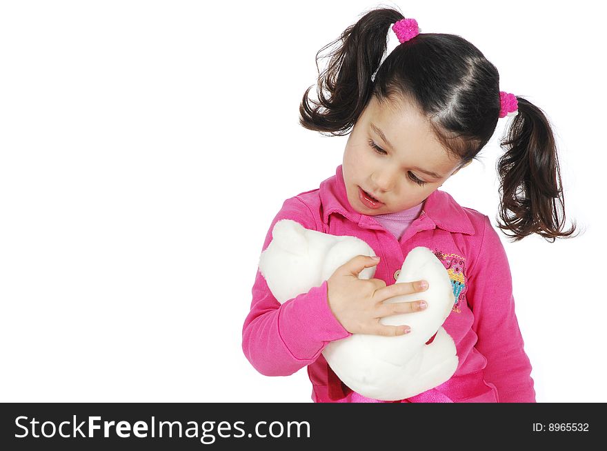 A little girl hugging a teddy bear