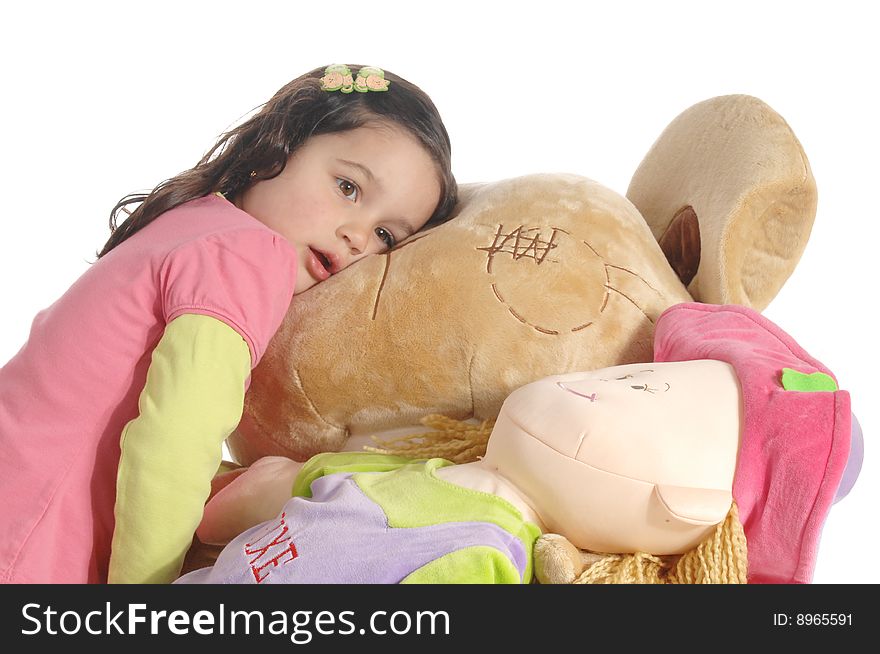 A little girl hugging a big teddy bear isolated on white background. A little girl hugging a big teddy bear isolated on white background