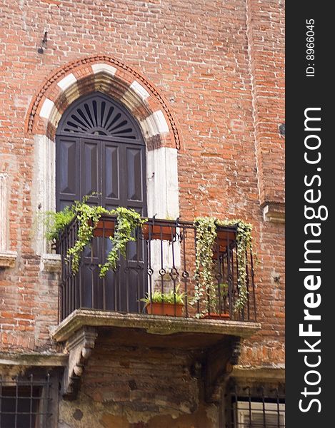 Balcony with door in ancient brick building in Verona Italy. Balcony with door in ancient brick building in Verona Italy