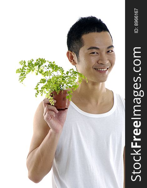 Young man holding up a green leaf. Young man holding up a green leaf