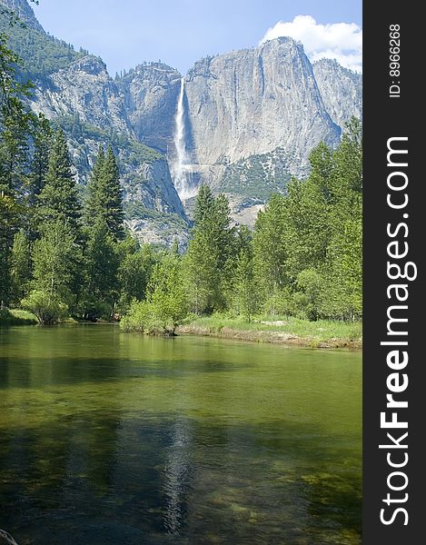 Yosemite Falls in the California Sierras reflected in the Merced river