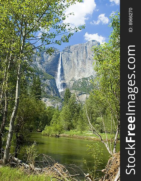 Yosemite Falls in the California Sierras reflected in the Merced river