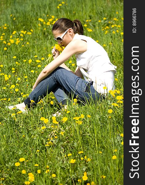 Young Woman In Nature Smelling Flowers