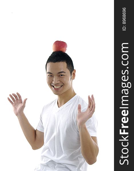 Funny young man having apple on his head. Funny young man having apple on his head