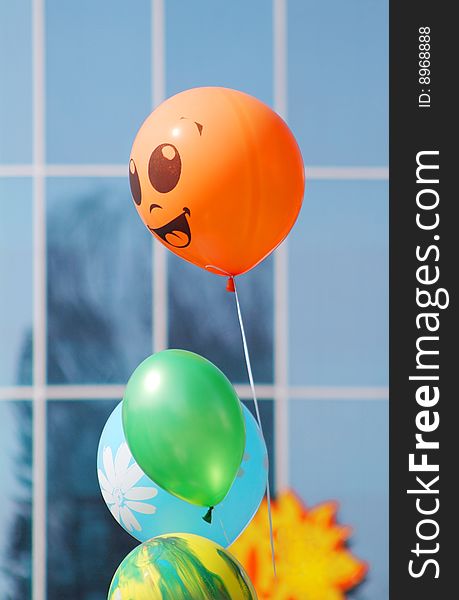 Colorful smiling ballons with the building background. Colorful smiling ballons with the building background