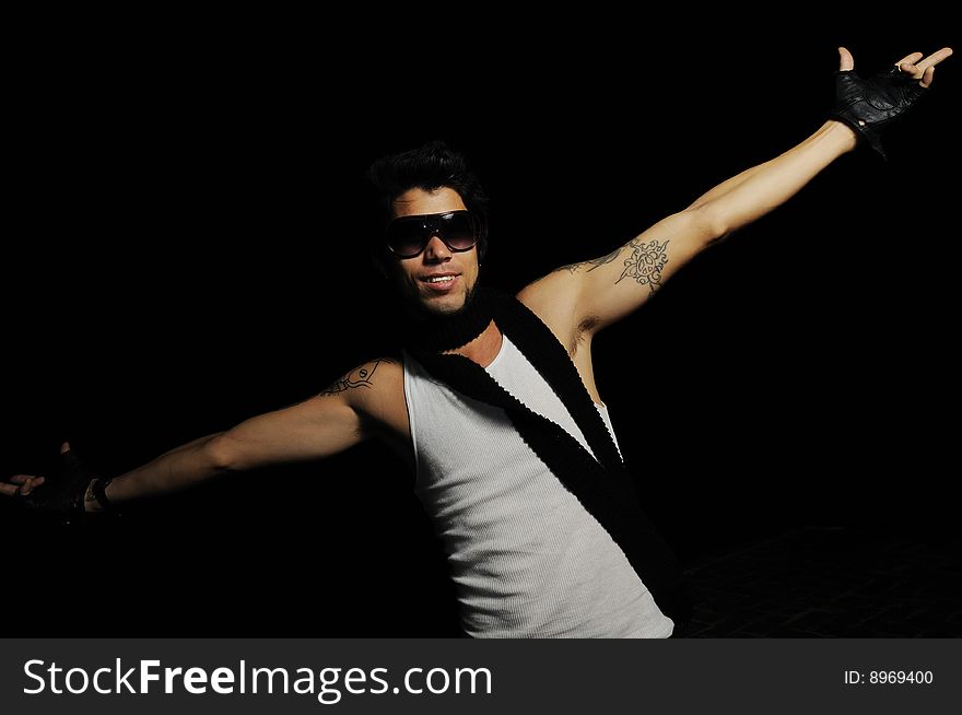 Portrait of young trendy male fashion model with open arms. Portrait of young trendy male fashion model with open arms