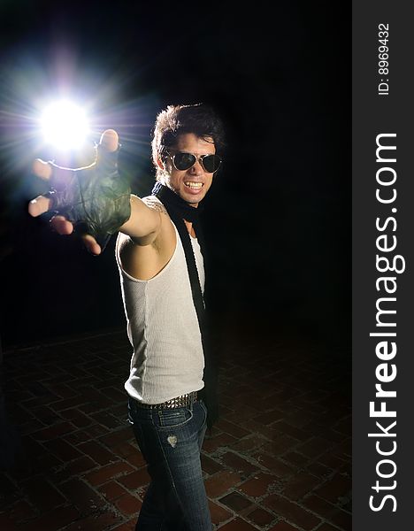 Portrait of young trendy male model holding light flare. Portrait of young trendy male model holding light flare
