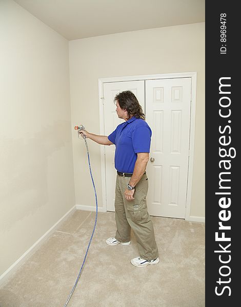 Contract painter updating colors of walls to speed up selling of home. Contract painter updating colors of walls to speed up selling of home