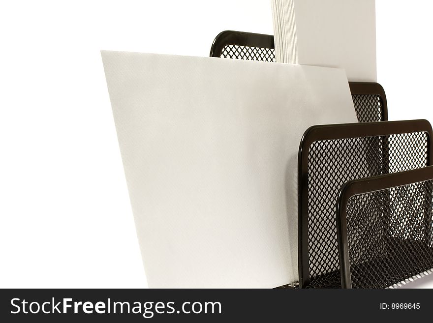 A mixture of vertical and horizontal envelopes in a business letter holder waiting to be sent. A mixture of vertical and horizontal envelopes in a business letter holder waiting to be sent