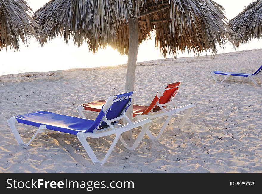 Beach chairs on tropical cuban beach at sunset. Beach chairs on tropical cuban beach at sunset