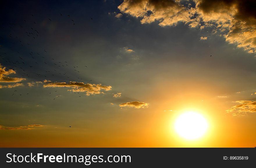 Sunset In Cloudy Skies