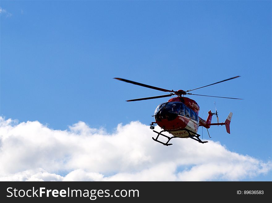 Helicopter flying in blue sky with cloudscape. Helicopter flying in blue sky with cloudscape.