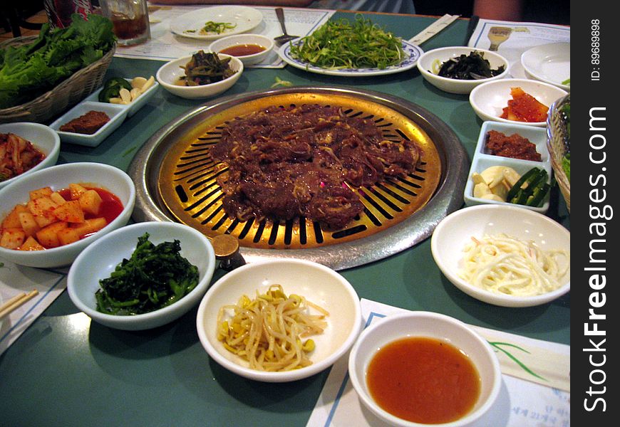 Many sides wait in anticipation while the meat begins to cook. Hae Woon Dae