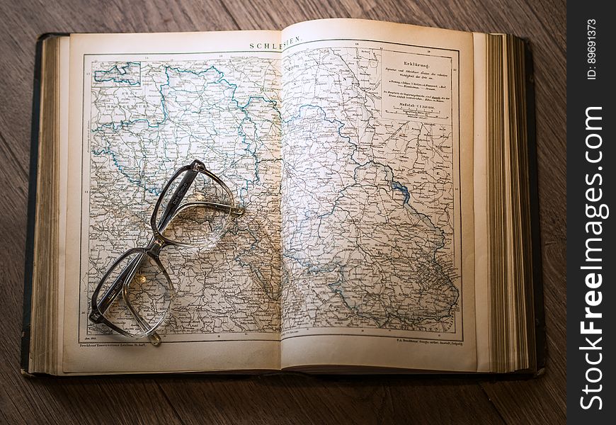 Black Framed Eyeglasses Map in Book
