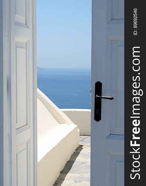 A door leading to a terrace with an ocean view. A door leading to a terrace with an ocean view.