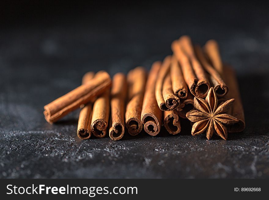 A stack of cinnamon sticks and a star anise. A stack of cinnamon sticks and a star anise.