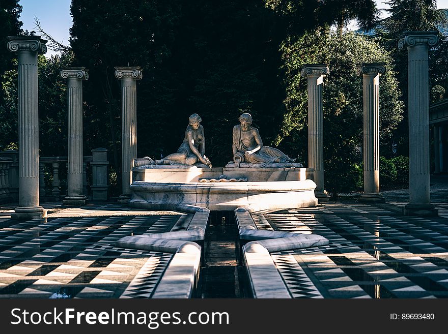 Statues and fountain with Greek pillars in outside gardens. Statues and fountain with Greek pillars in outside gardens.