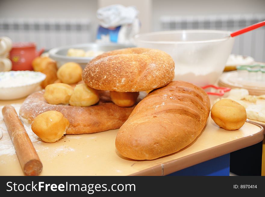 Fresh-baked bread and dough on the table