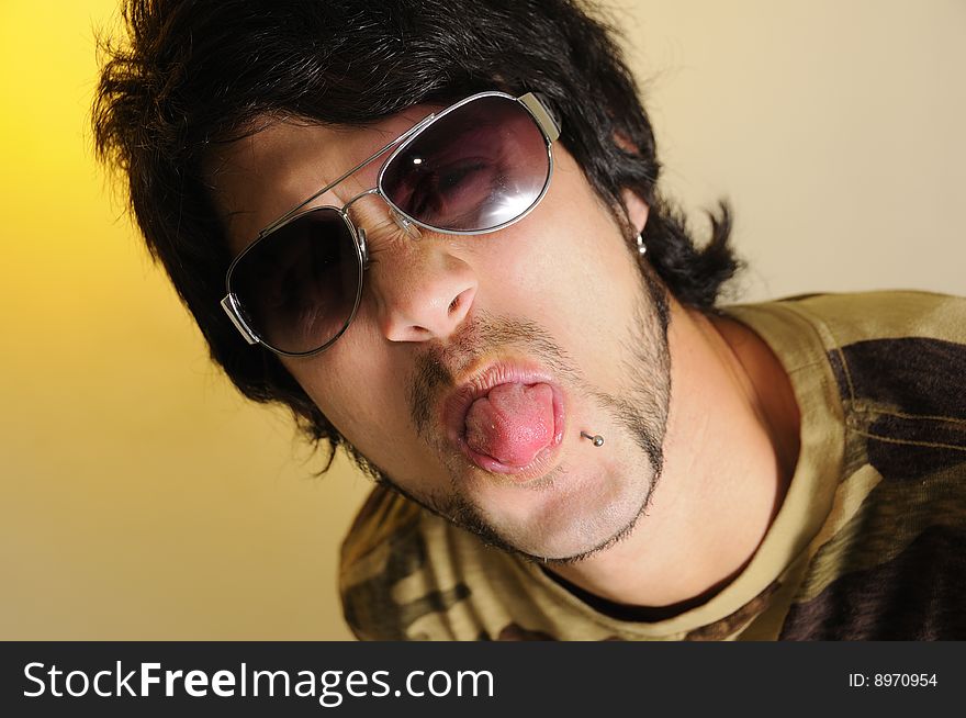 Portrait of young trendy man making funny faces