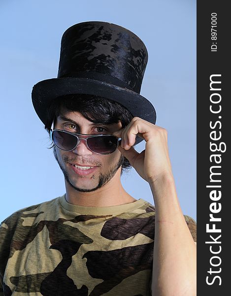 Portrait of trendy young man posing with a hat. Portrait of trendy young man posing with a hat