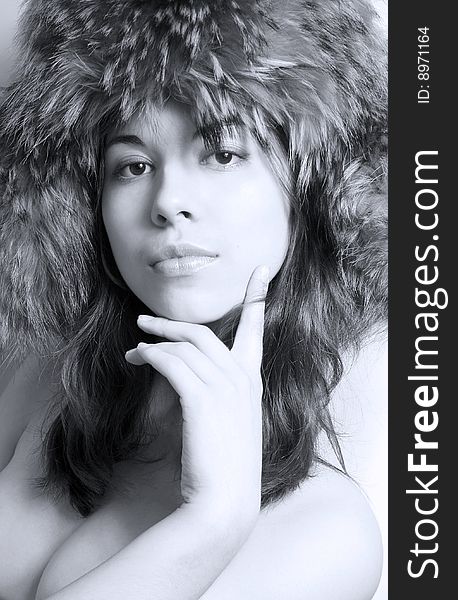 Portrait of the girl in a fur cap.