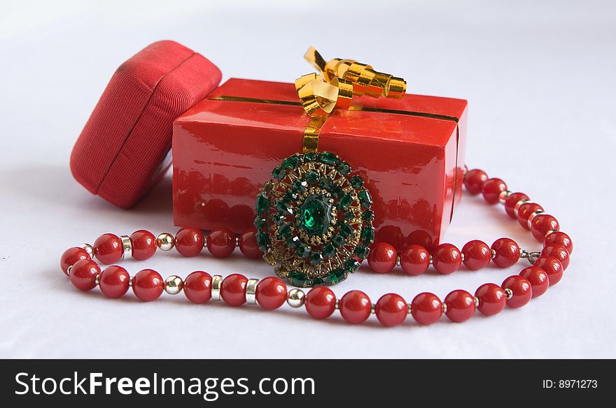 Two red boxes and brooch with beads