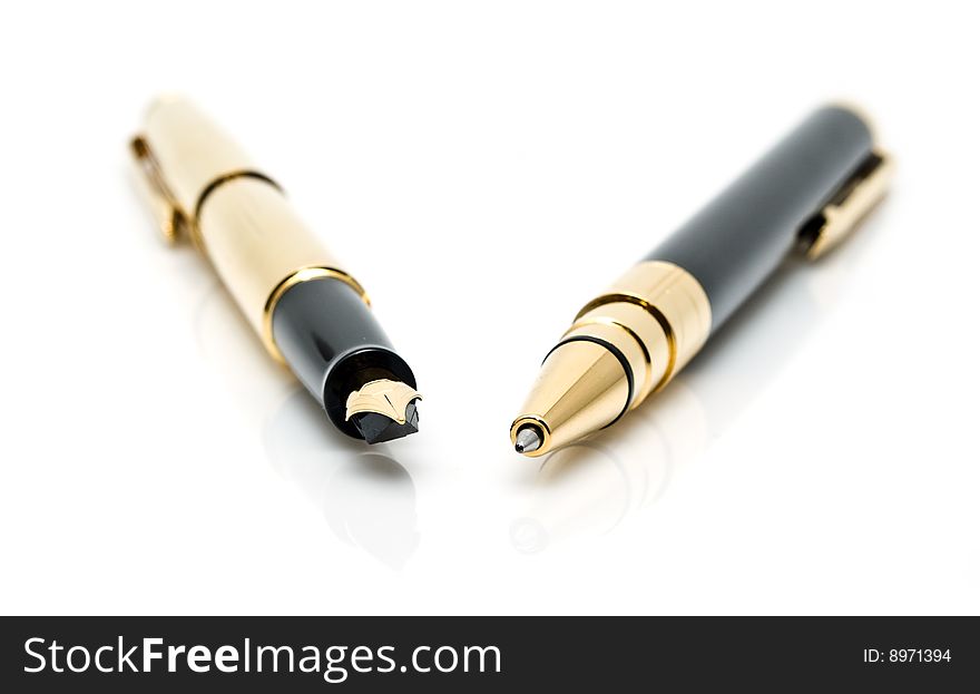 Gold pens on a white background