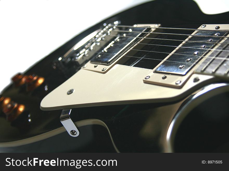 Closeup of a black lead guitar. Orientation: Landscape. Closeup of a black lead guitar. Orientation: Landscape