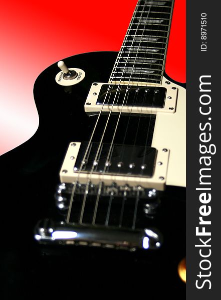 Closeup of a black lead guitar. Orientation: portrait. Closeup of a black lead guitar. Orientation: portrait