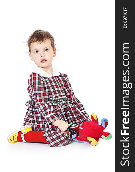 Little girl in checkered dress on white background