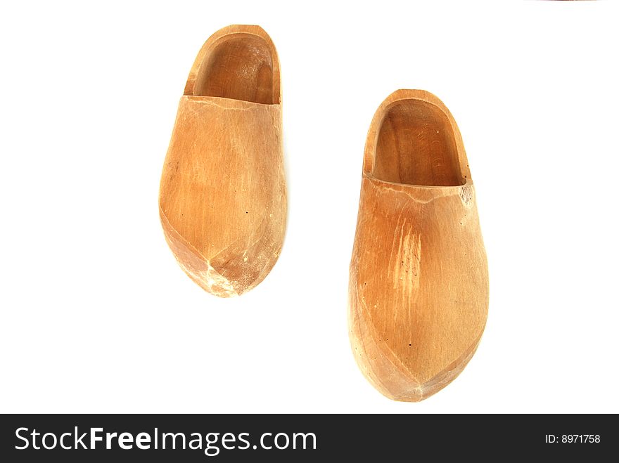 A pair of ancient wooden shoes on white. A pair of ancient wooden shoes on white