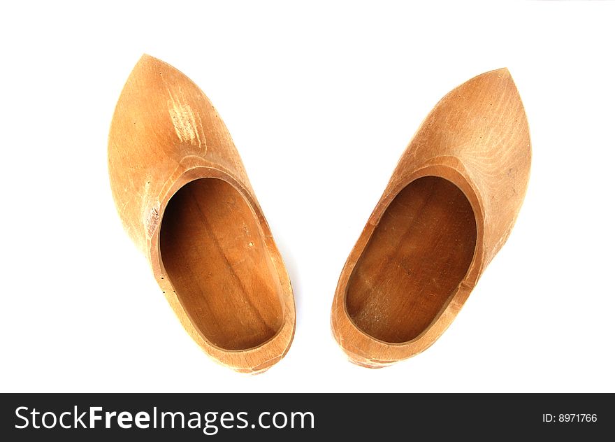 A pair of ancient wooden shoes on white. A pair of ancient wooden shoes on white