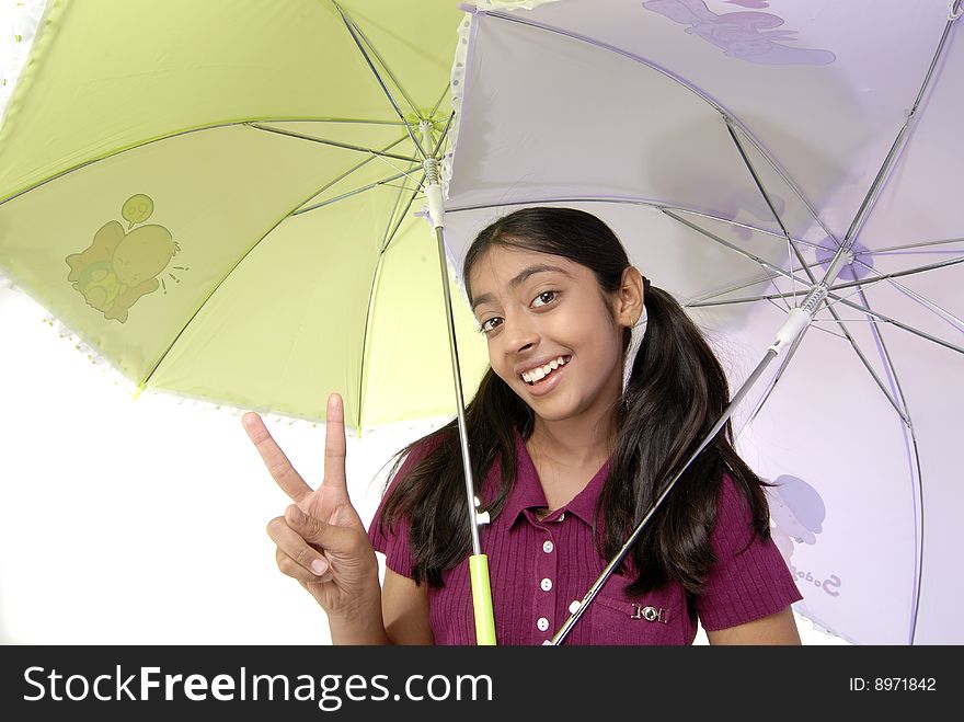 Cute girl showing two finger under two umbrella. Cute girl showing two finger under two umbrella