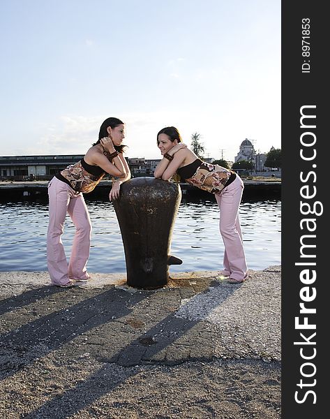 Portrait of two young twin girls posing outdoors. Portrait of two young twin girls posing outdoors