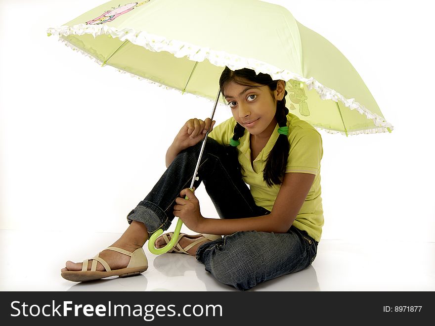 Girl sitting under green umbrella. Girl sitting under green umbrella