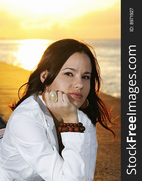 Portrait of young beautiful woman posing outdoors at sunset. Portrait of young beautiful woman posing outdoors at sunset