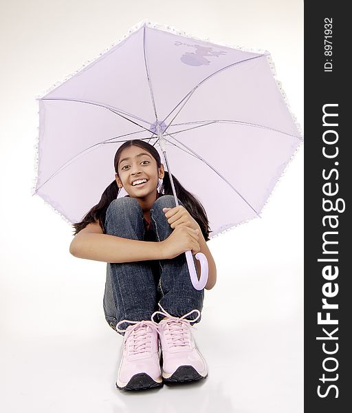 Portrait of girl sitting under purple umbrella. Portrait of girl sitting under purple umbrella