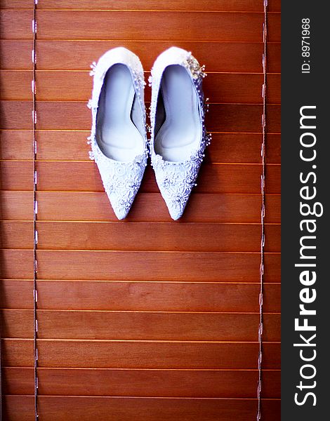 White bridal shoe on board